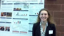 Bailey Gensheimer in front of research poster at Denman Undergraduate Research Forum
