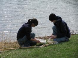 students processing aquatic samples by lake
