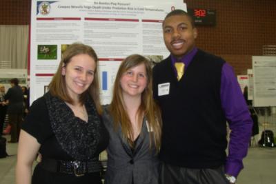 Brittany Coovert, Madison Stuhlreyer, and Kyle Ball  in front of research poster at Denman