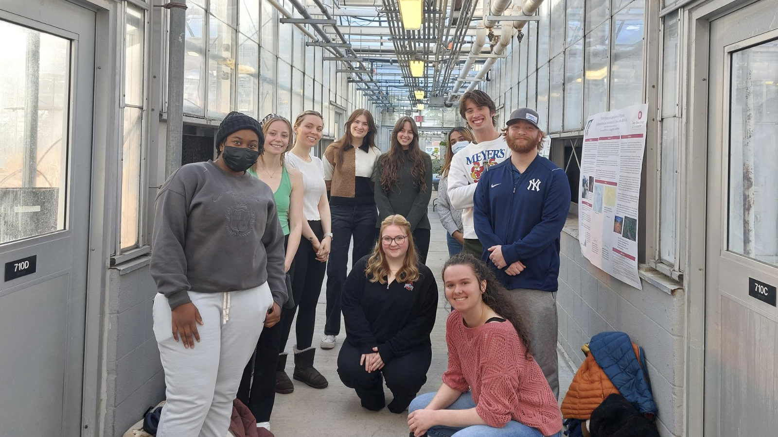 BEE Program students posing in a hallway of the Biological Sciences Greenhouse