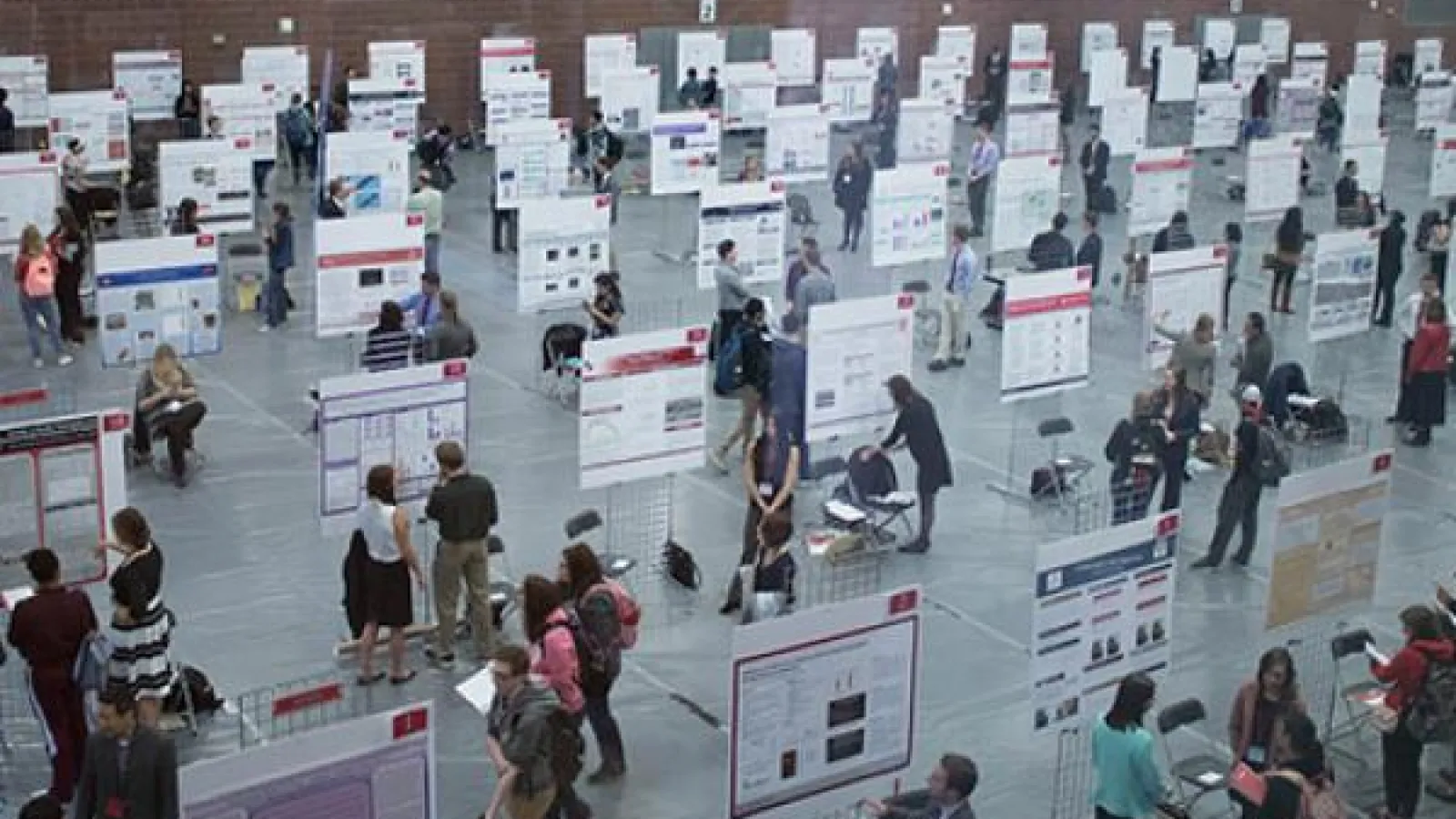 bird's eye view of research posters and presenters at Denman