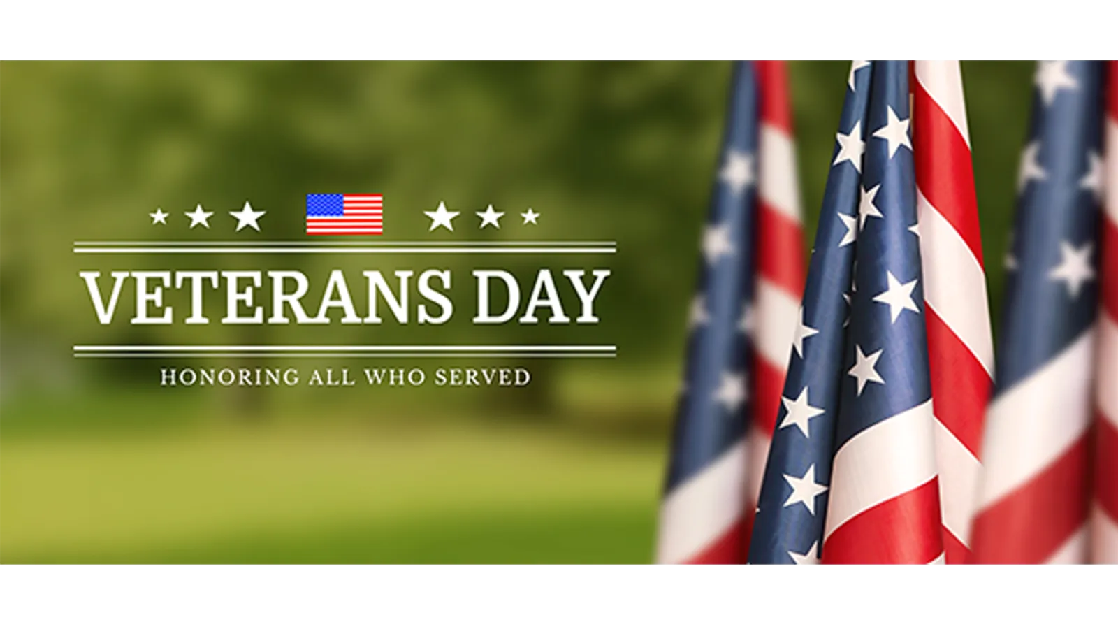 Veterans Day - Honoring all who served - 3 flagpoles with American flags on green landscape