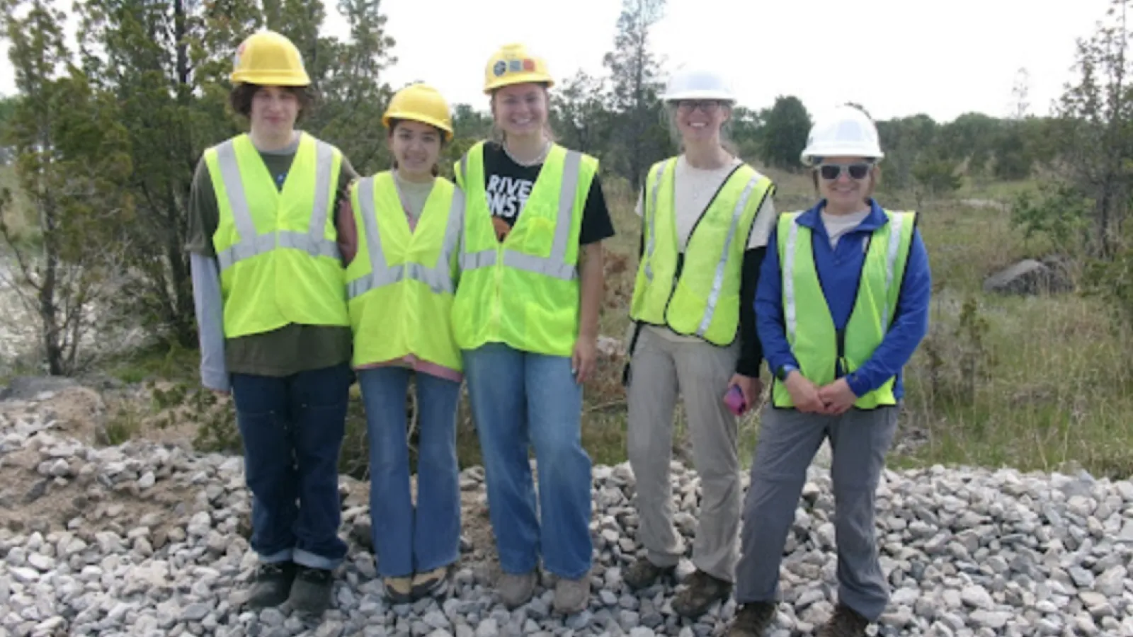 Ethan, Ayla, Ava, Jenny Finfera from USFWS and Amber Bellamy from USFWS outdoors in reflective vests and hard hats