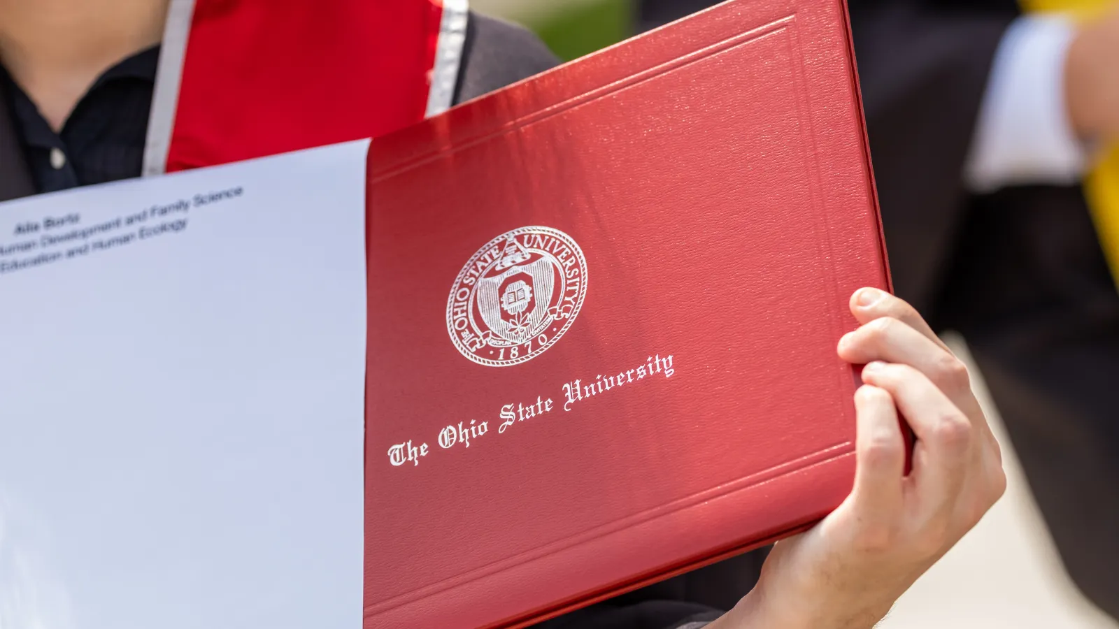 closeup of OSU Diploma being removed from white envelope