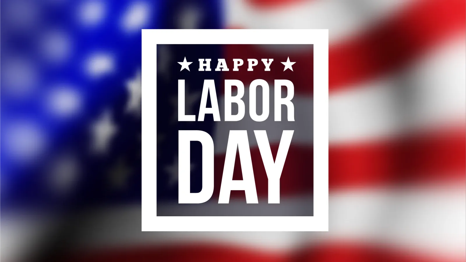 text block in white font reading Labor Day with blurred American flag in background