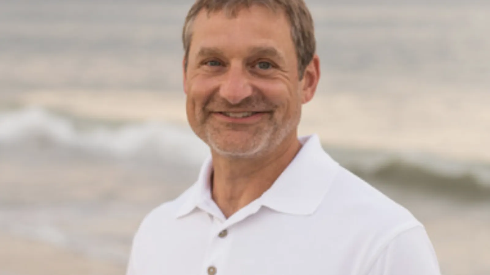 Stuart Ludsin standing on beach