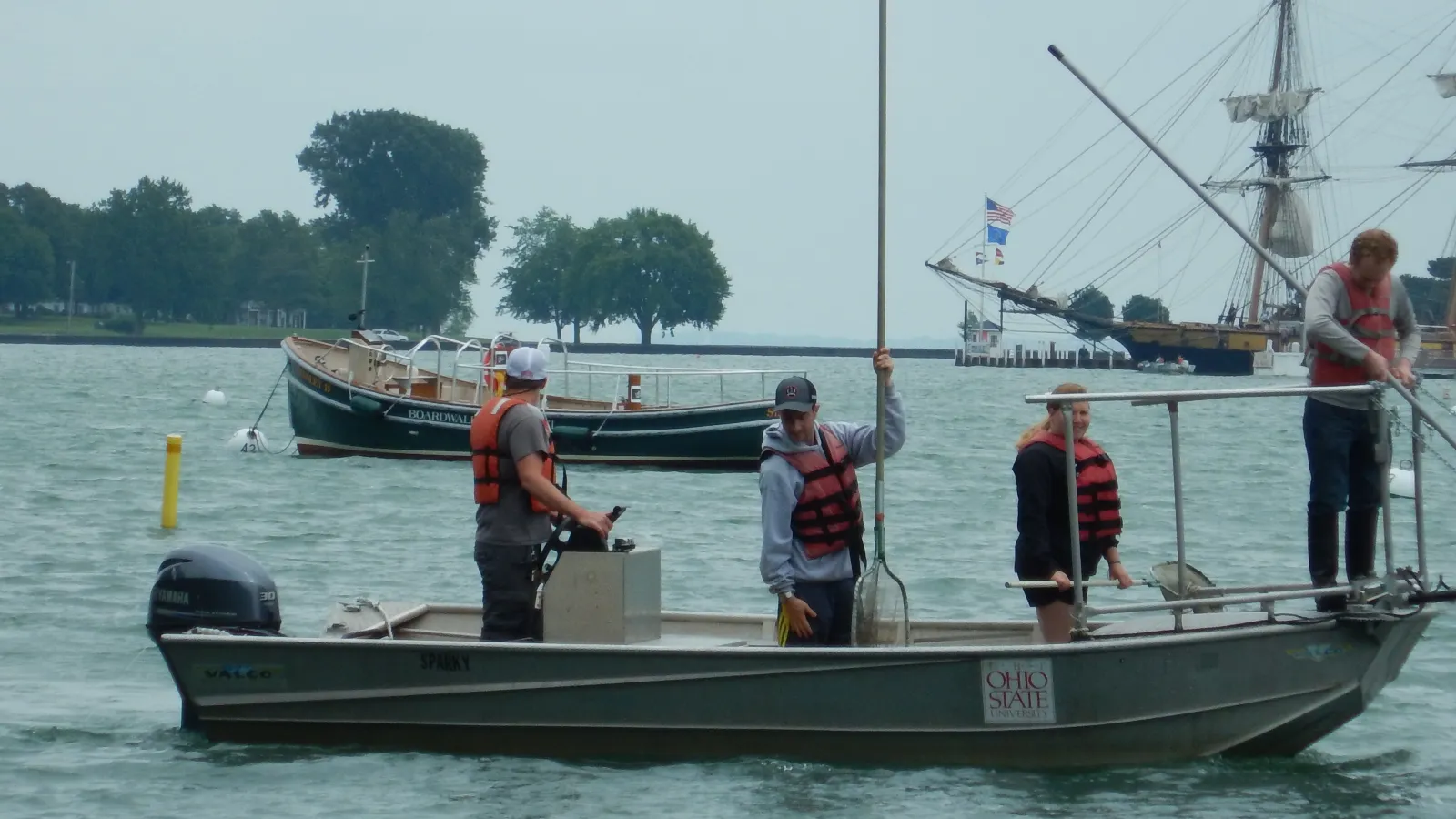 SL Asst Mgr Kevin Hart students Harrison Freid Emily Krohn Ross in front of taxi boat and Perrys Monument