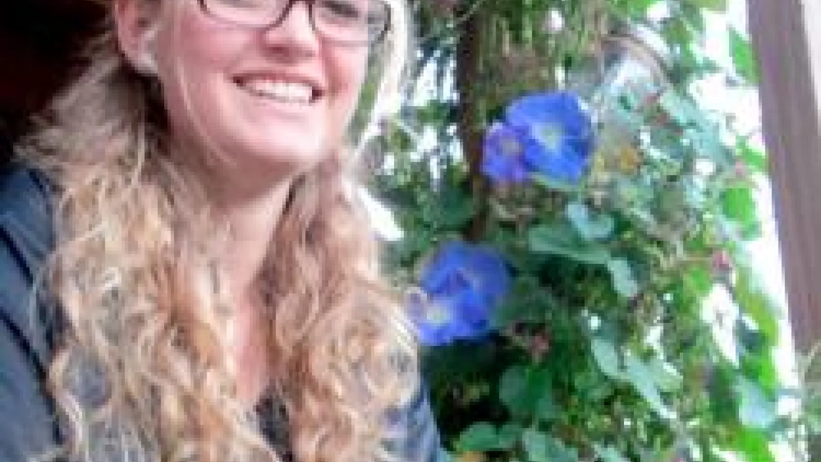 Dawn Musil posing by flowering vine