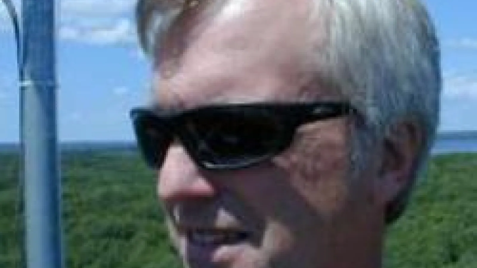 closeup of Curtis in sunglasses atop tower in Michigan
