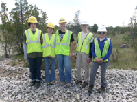 Ethan, Ayla, Ava, Jenny Finfera from USFWS and Amber Bellamy from USFWS outdoors in reflective vests and hard hats