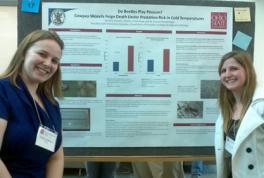 Brittany Coovert and Madi Stuhlreyer in front of research poster at NMS Forum