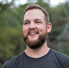 headshot of Rob Denton standing outdoors in front of tree line