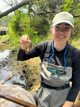 Meredith Bennett standing outside holding crayfish