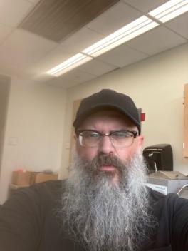 headshot of Chris Randle wearing black ball cap indoors