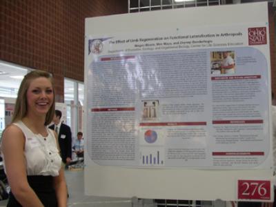 Megan Moore in front of research poster at Denman