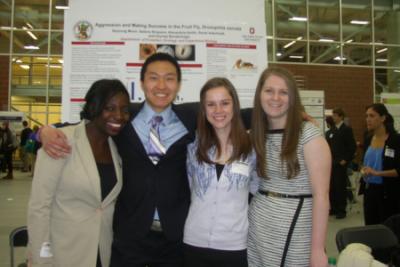 Seyoung Moon, Sabina Simpson, Alexandria Smith, and Sarah Aderholdt in front of research poster at Denman