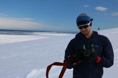 drew spacht in antarctica holding camera