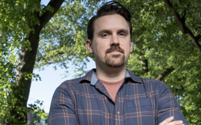 headshot of Brady Hardiman outdoors under tree canopy