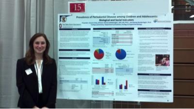 Autumn Gray Research Abstract Autumn Gray in front of research poster at Denman Forum