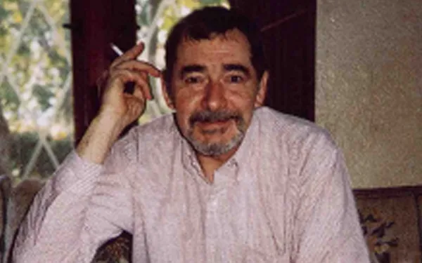head and shoulders shot of Johnston holding cigarette