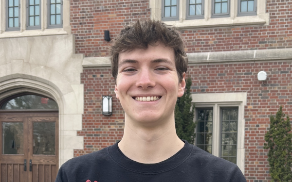 head and shoulders shot of Connor Ferguson standing in front of building