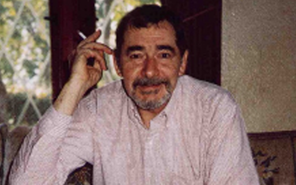head and shoulders shot of Johnston holding cigarette
