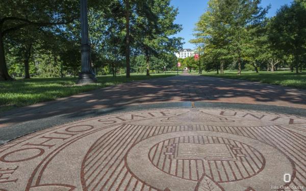 university seal on the oval in summer