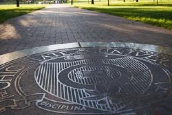 closeup of OSU seal embedded in the main brick sidewalk on the Oval