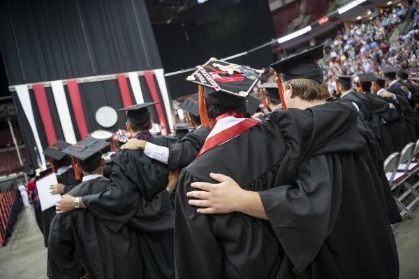 graduates at schottenstein center singing Carmen Ohio