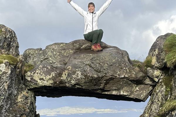 Erin Murray sitting on elevated rock structure 