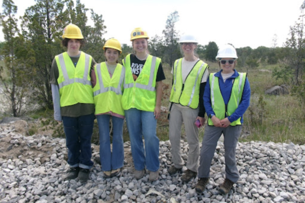 Ethan, Ayla, Ava, Jenny Finfera from USFWS and Amber Bellamy from USFWS outdoors in reflective vests and hard hats
