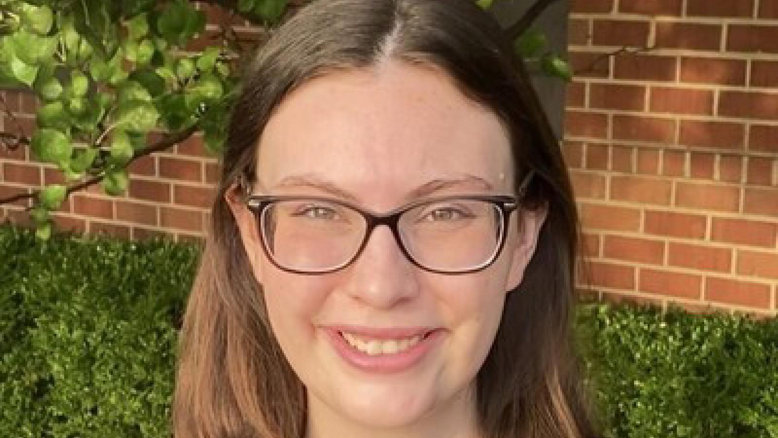 headshot of Madison VonDeylen outside in front of brick wall