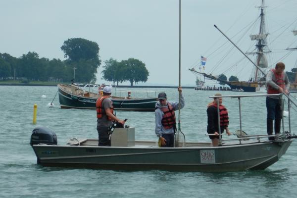 SL Asst Mgr Kevin Hart students Harrison Freid Emily Krohn Ross in front of taxi boat and Perrys Monument