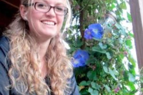 Dawn Musil posing by flowering vine