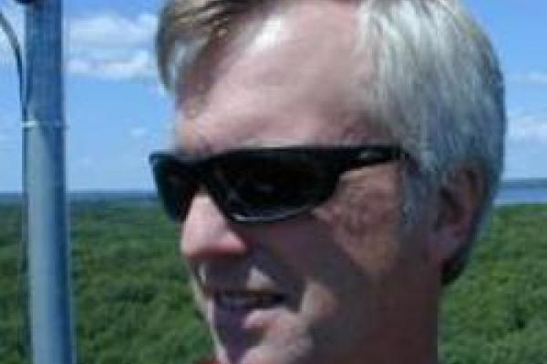 closeup of Curtis in sunglasses atop tower in Michigan