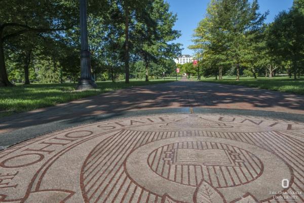 university seal on the oval in summer