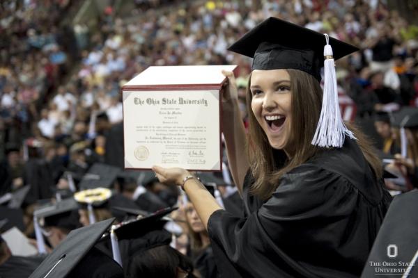 graduate holding diploma