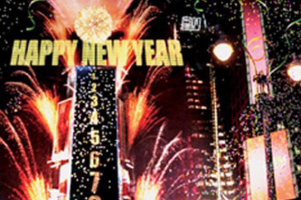 nighttime city scape with fireworks and New Year's Eve ball drop tower