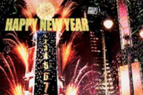 nighttime city scape with fireworks and New Year's Eve ball drop tower