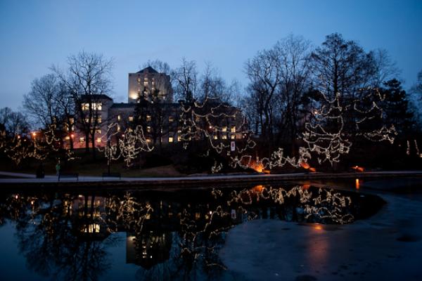 Pomerene Hall over Mirror Lake decorated with white holiday lights for winter break