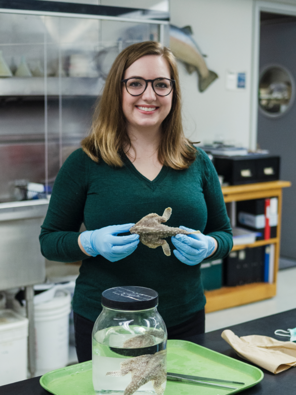 Liz Santos holding preserved fish in lab