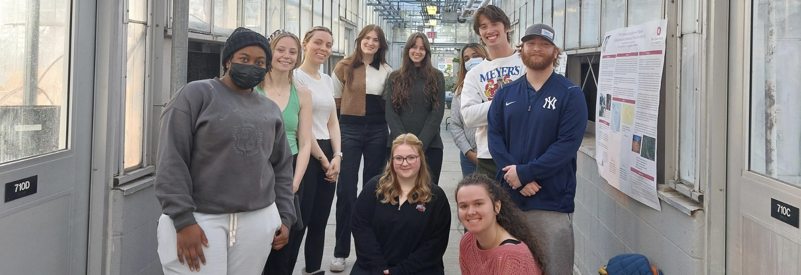 BEE Program students posing in a hallway of the Biological Sciences Greenhouse