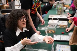 closeup of MBD volunteer showing specimen to Open House guest