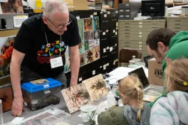 MBD volunteer shows specimens to Open House attendees