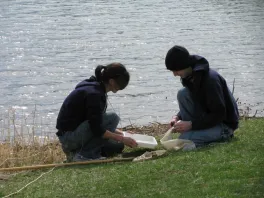 students processing aquatic samples by lake